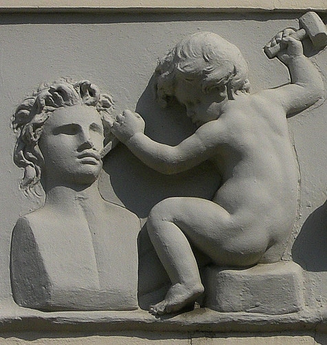 chiseling baby statue