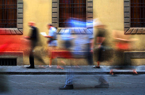 blurry people on a sidewalk