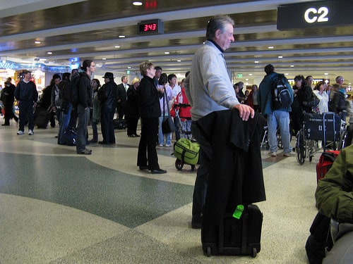 man waiting in line at airport