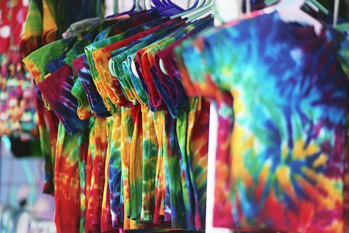 tie dye shirts on a rack