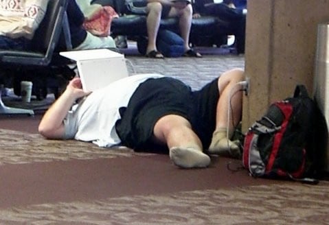 man sleeping in airport