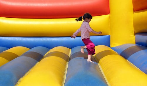 girl jumping in bouncy castle