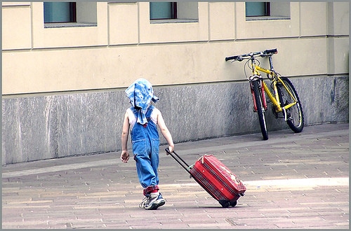 kid with rolling suitcase