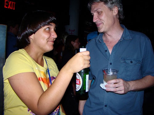 woman sharing a beer