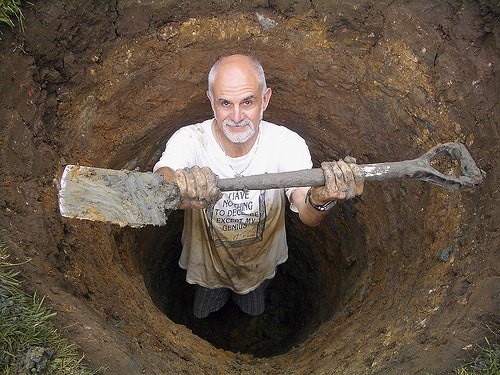 man digging hole