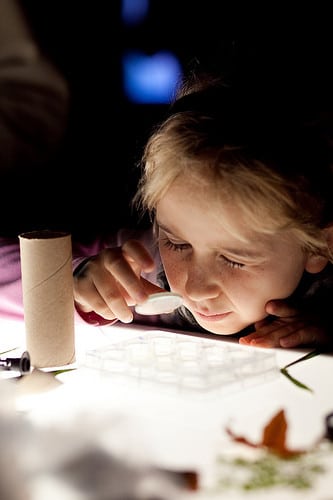 girl looking through microscope