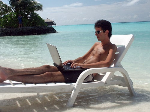 working on laptop at beach