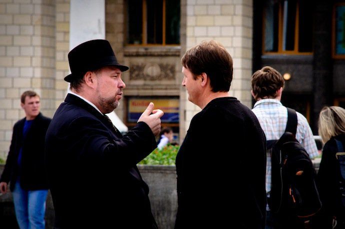 two men talking outside